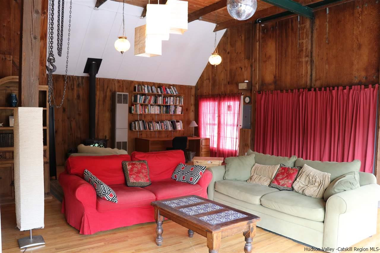 72 Little Deer Road Mount Tremper, NY 12457 - Photo 3 of 21 a living room with furniture a lamp and a window