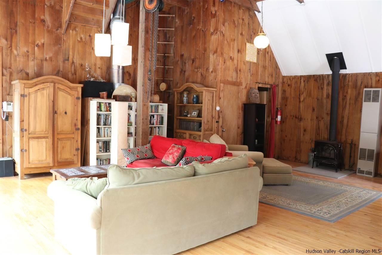 72 Little Deer Road Mount Tremper, NY 12457 - Photo 4 of 21 a living room with a couch and a chandelier