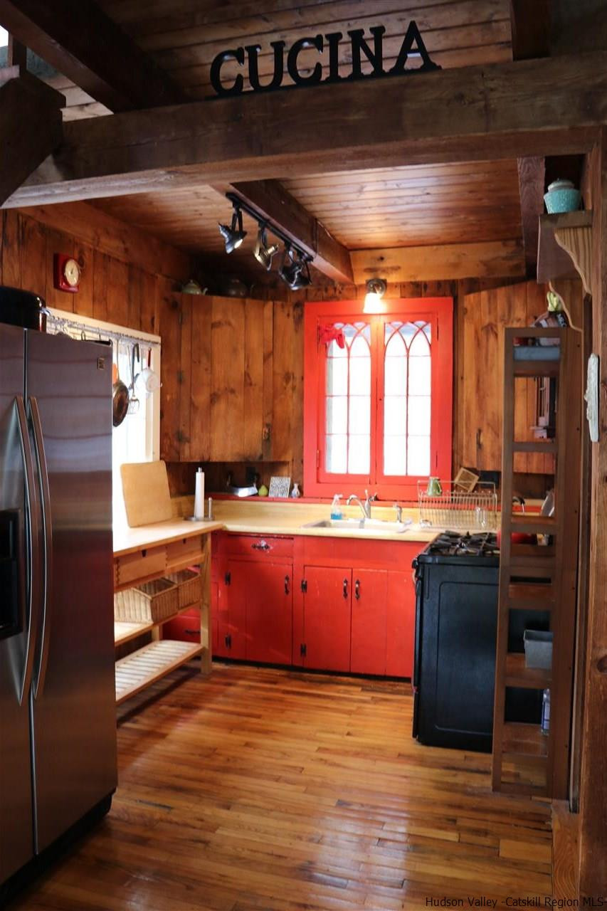 72 Little Deer Road Mount Tremper, NY 12457 - Photo 8 of 21 a kitchen with granite countertop a refrigerator a sink a stove and wooden floors