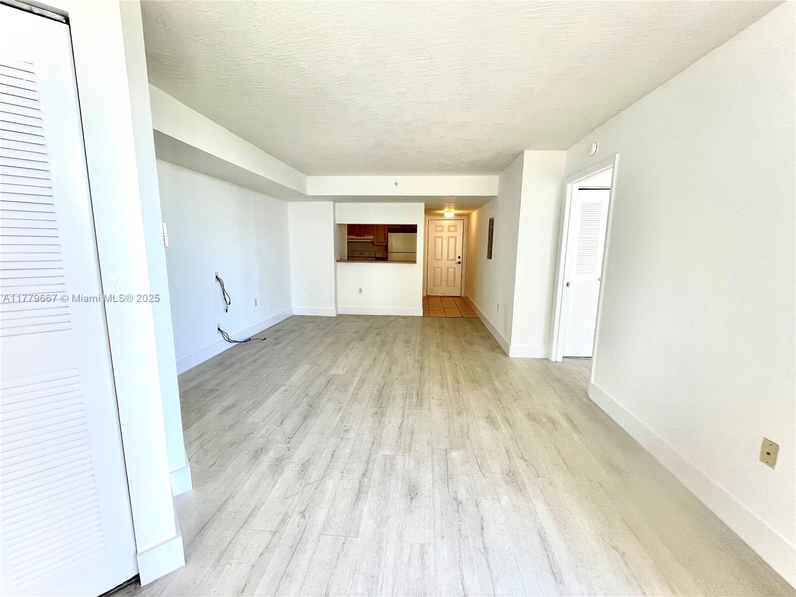 102 Southwest 6th Avenue, Unit 701 Miami, FL 33130 - Photo 5 of 25 a view of a room with wooden floor and a window