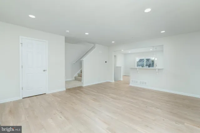 a view of an empty room with a kitchen