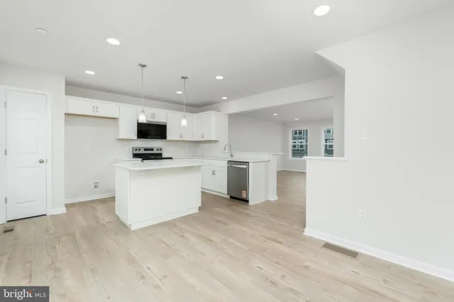 a view of kitchen with white cabinets and white appliances