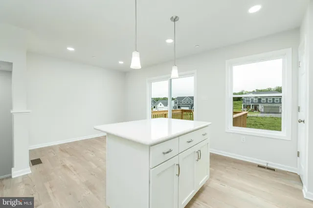 a view of a kitchen with marble countertop cabinets and a wooden floor