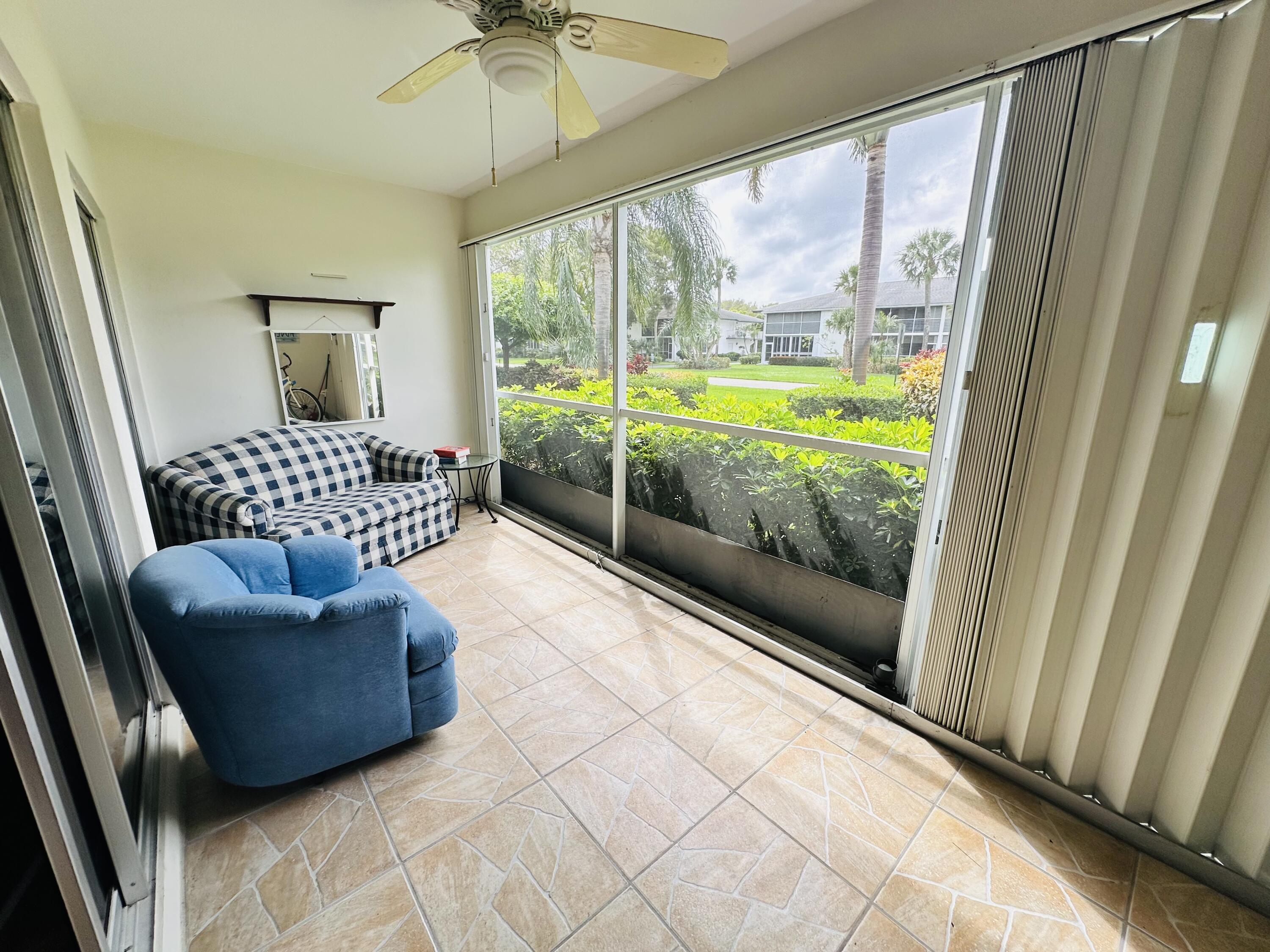 3 Garden Street, Unit 105K Tequesta, FL 33469 - Photo 12 of 41 a living room with furniture and a floor to ceiling window