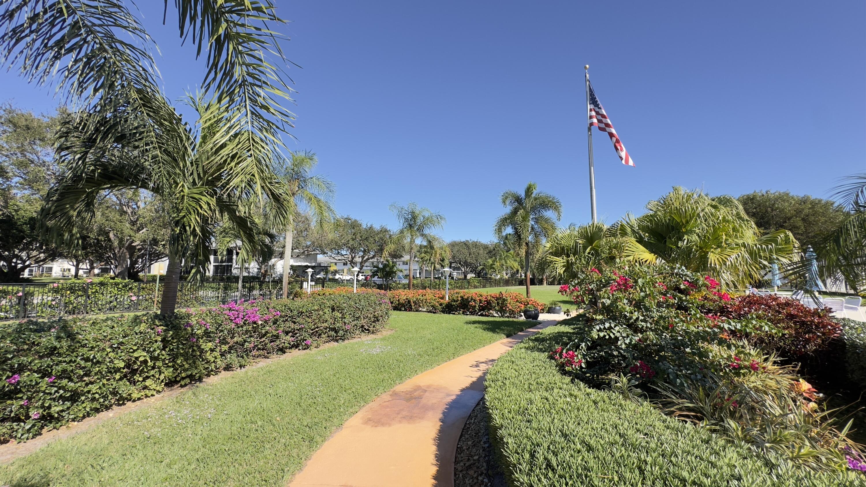 3 Garden Street, Unit 105K Tequesta, FL 33469 - Photo 14 of 41 a view of a garden with a house in the background
