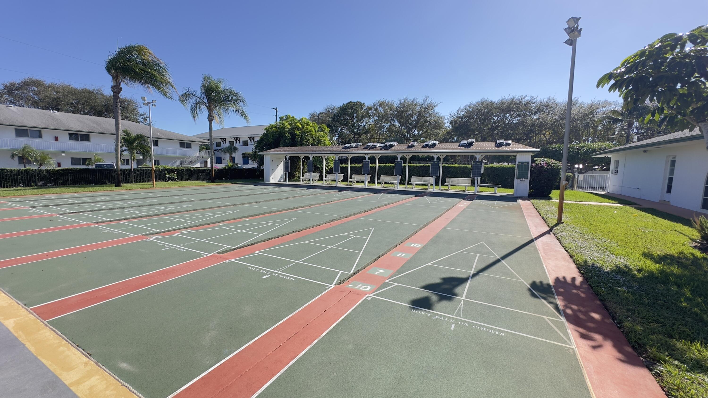 3 Garden Street, Unit 105K Tequesta, FL 33469 - Photo 18 of 41 a view of a tennis ground with large trees