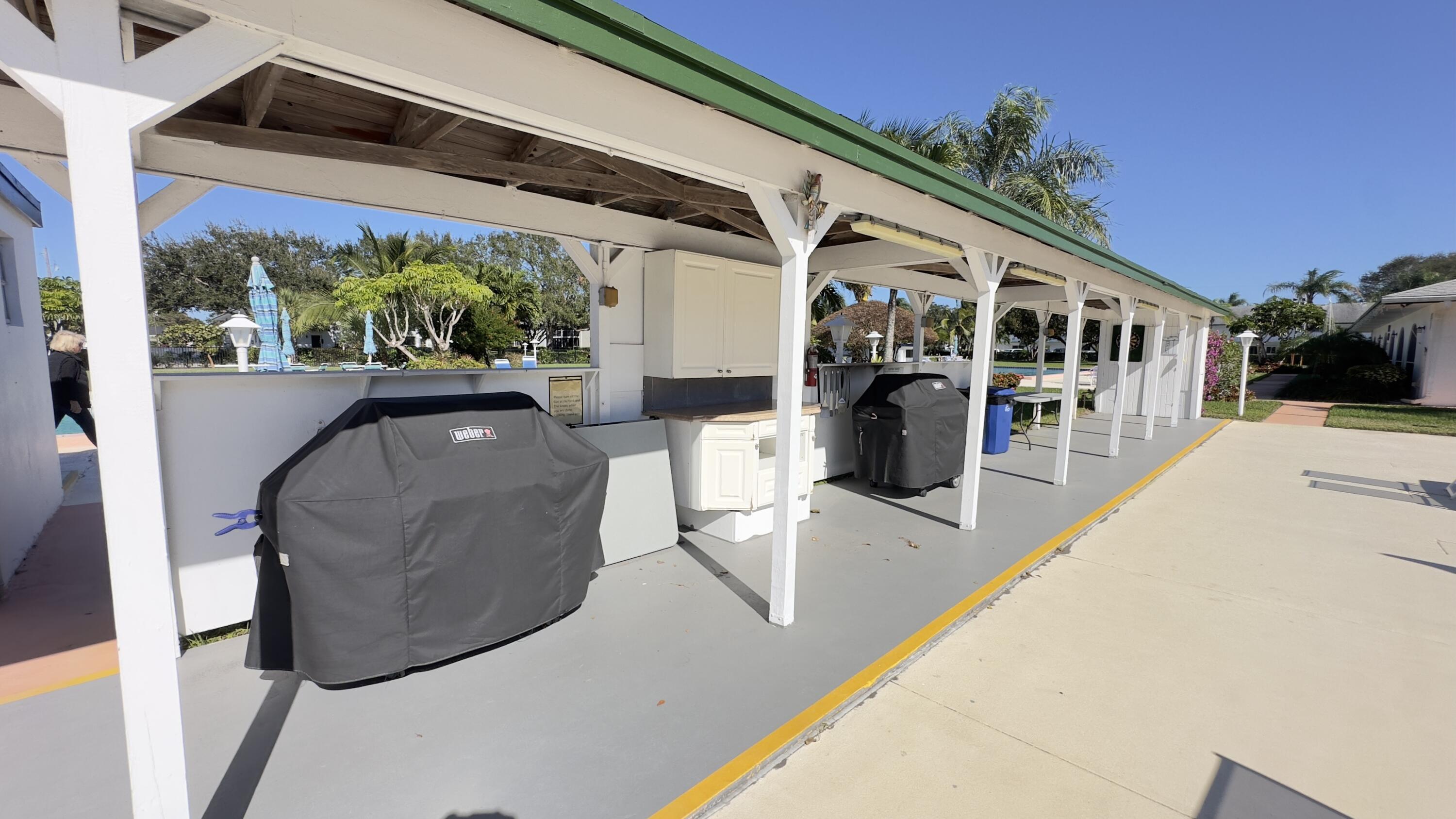3 Garden Street, Unit 105K Tequesta, FL 33469 - Photo 19 of 41 a view of a patio with couches and potted plants