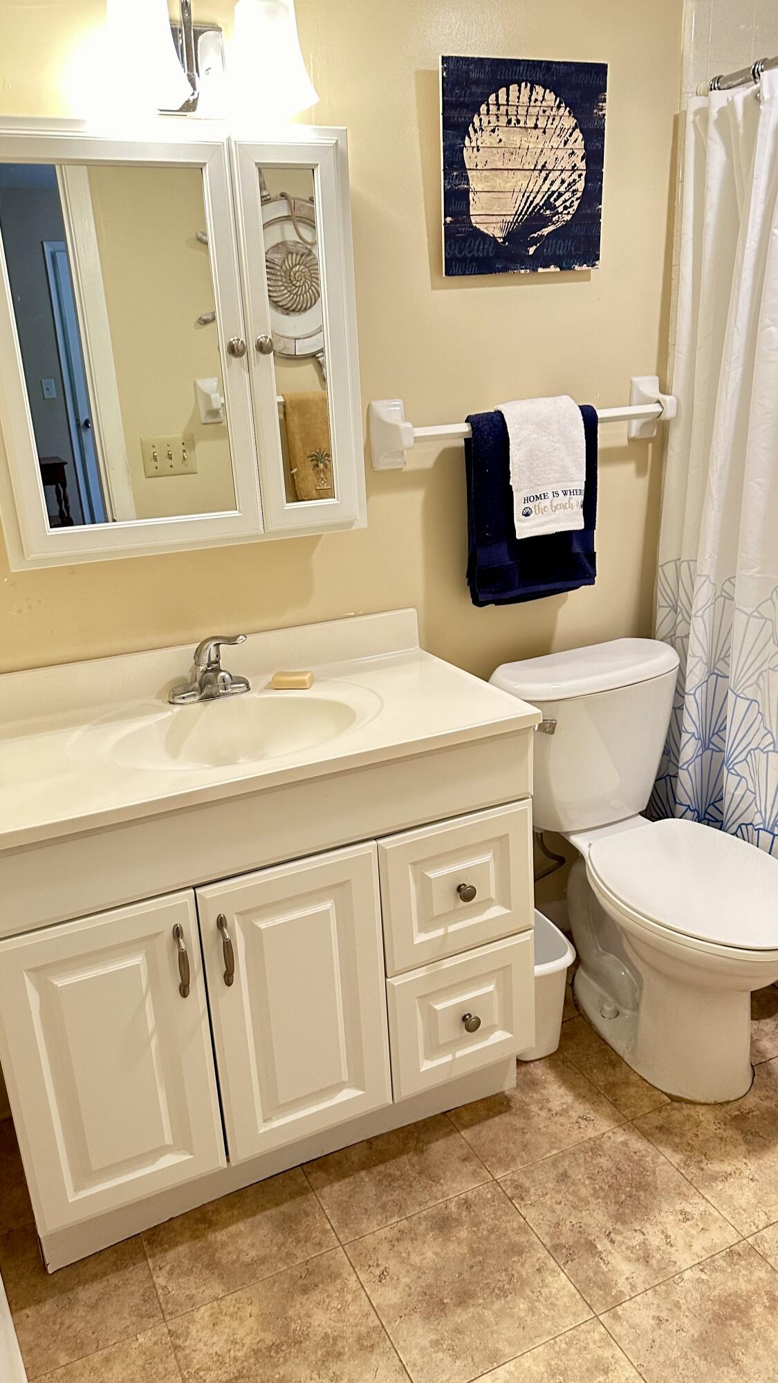 3 Garden Street, Unit 105K Tequesta, FL 33469 - Photo 29 of 41 a bathroom with a toilet sink and mirror