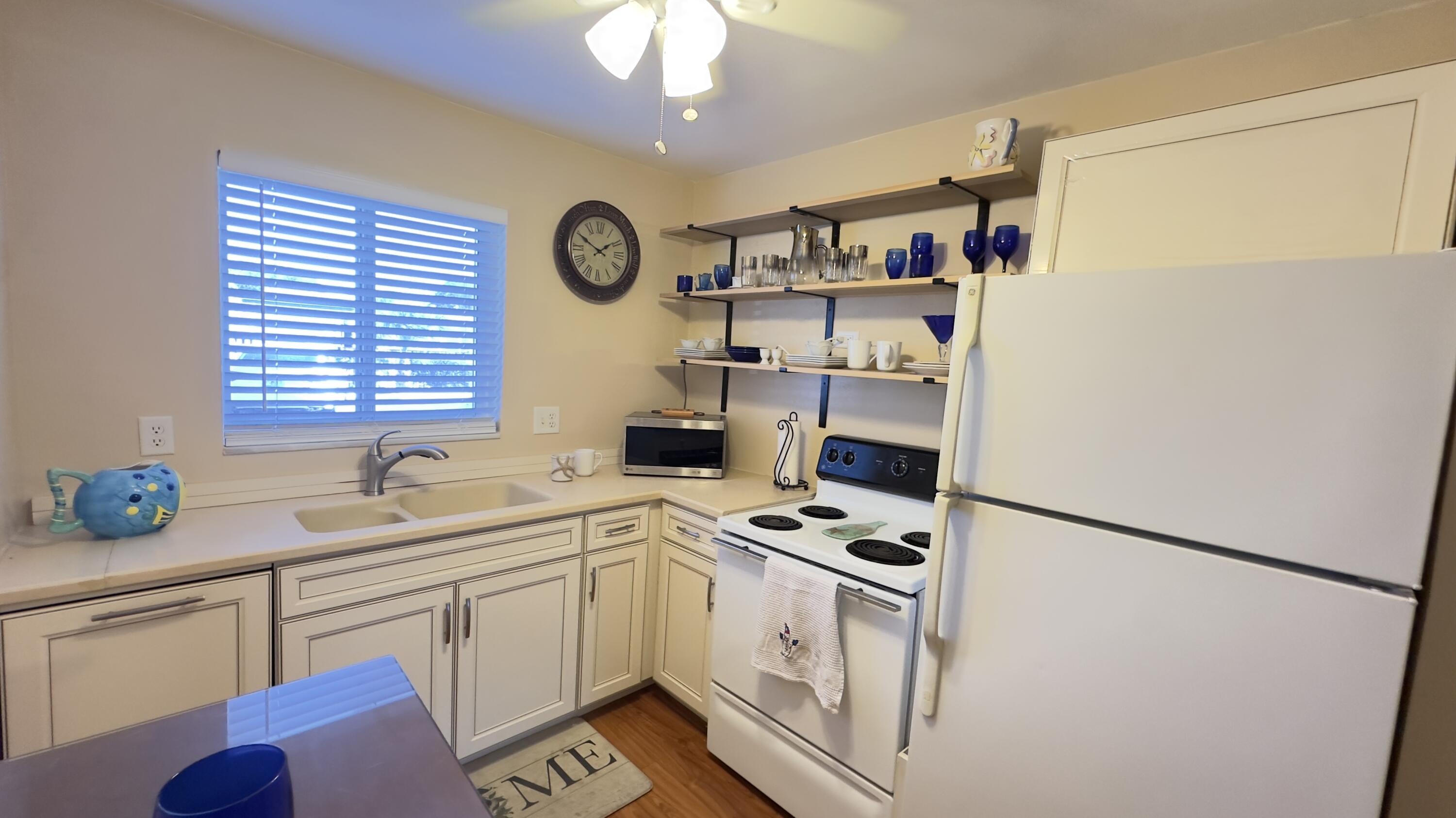 3 Garden Street, Unit 105K Tequesta, FL 33469 - Photo 6 of 41 a kitchen with stainless steel appliances a sink cabinets and a window
