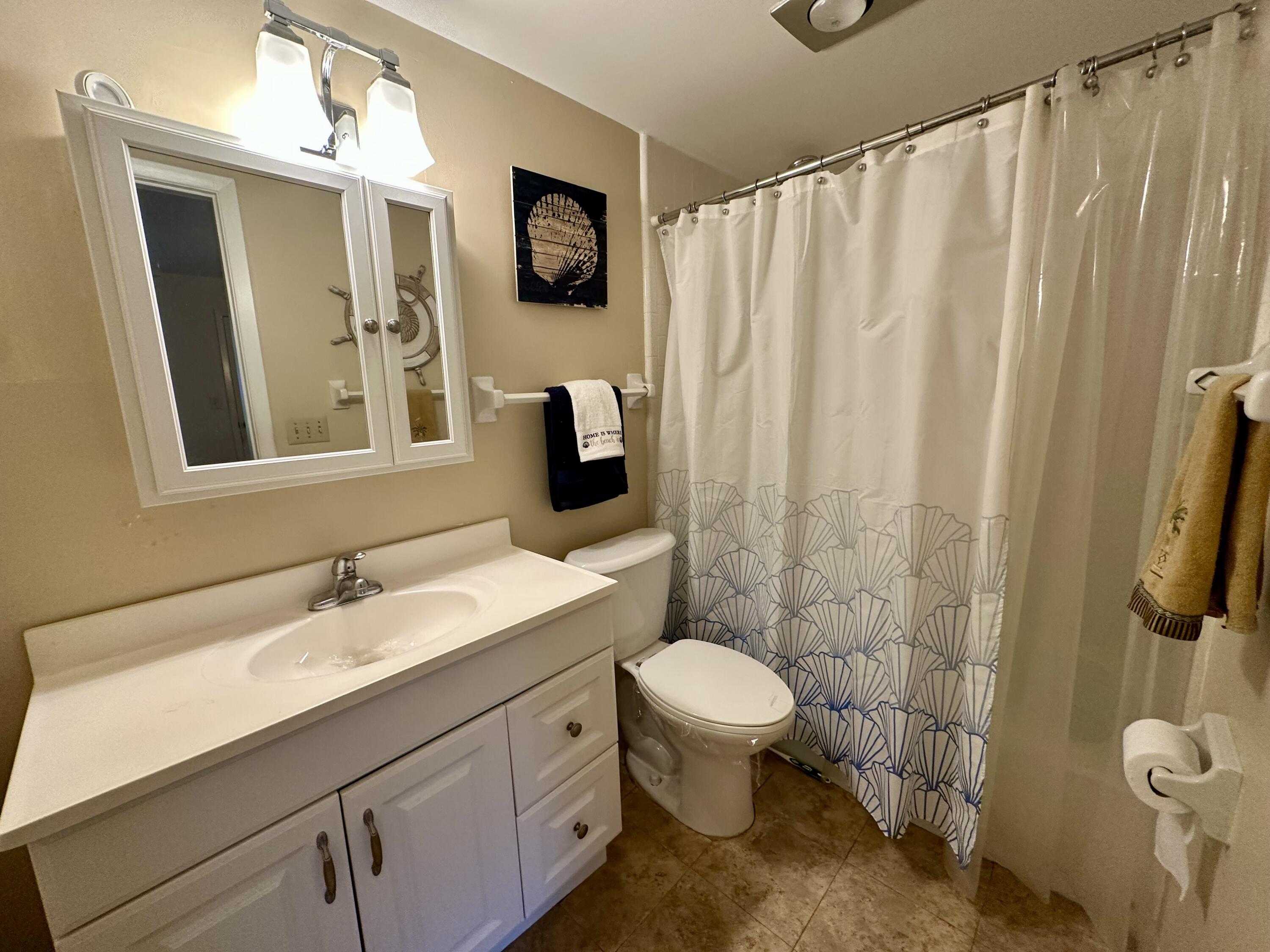 3 Garden Street, Unit 105K Tequesta, FL 33469 - Photo 10 of 41 a bathroom with a sink toilet and shower