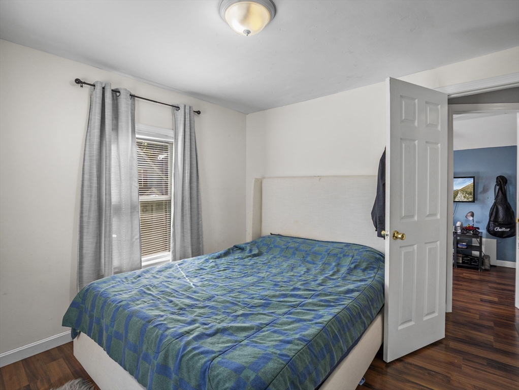 85 B Street Lowell, MA 01851 - Photo 18 of 42 a bedroom with a bed and wooden floor