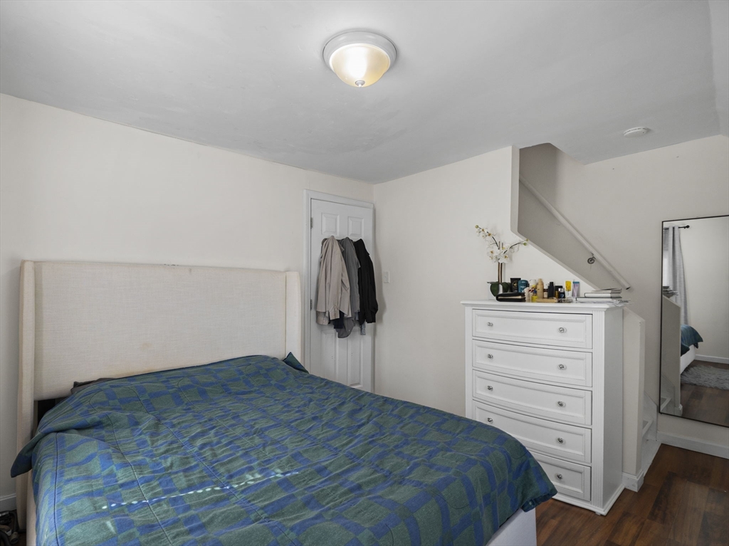 85 B Street Lowell, MA 01851 - Photo 20 of 42 a bedroom with a bed and a flat tv screen on the dresser