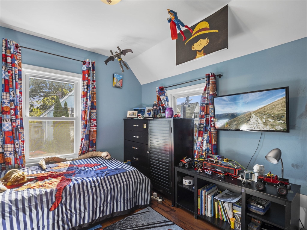 85 B Street Lowell, MA 01851 - Photo 26 of 42 a bedroom with a bed and a flat screen tv