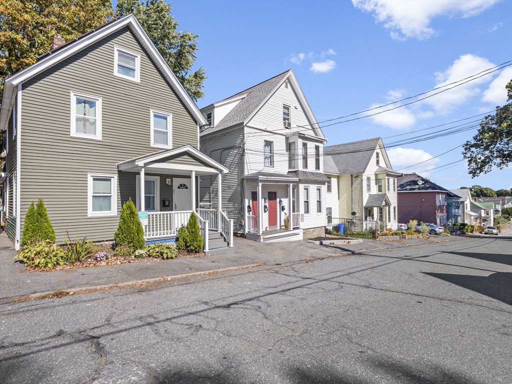 85 B Street Lowell, MA 01851 - Photo 30 of 42 a front view of a house with a porch