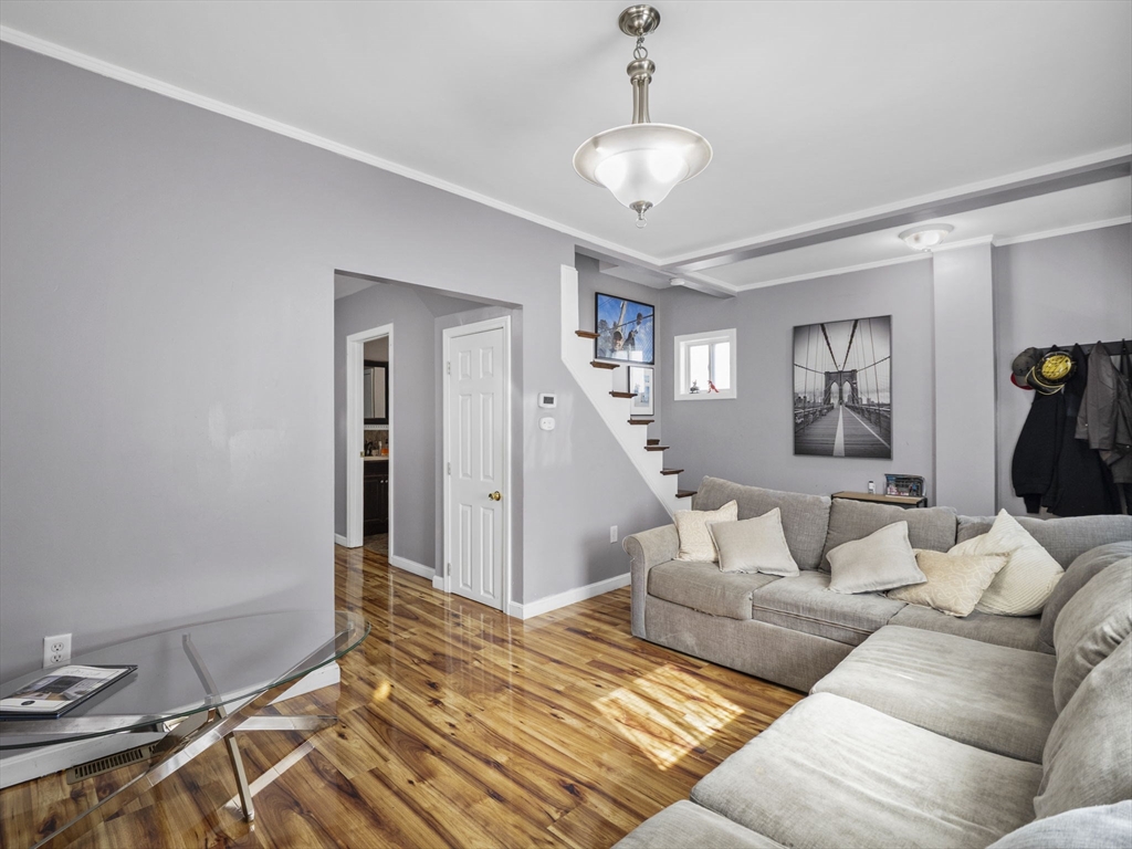 85 B Street Lowell, MA 01851 - Photo 4 of 42 a living room with furniture and a chandelier