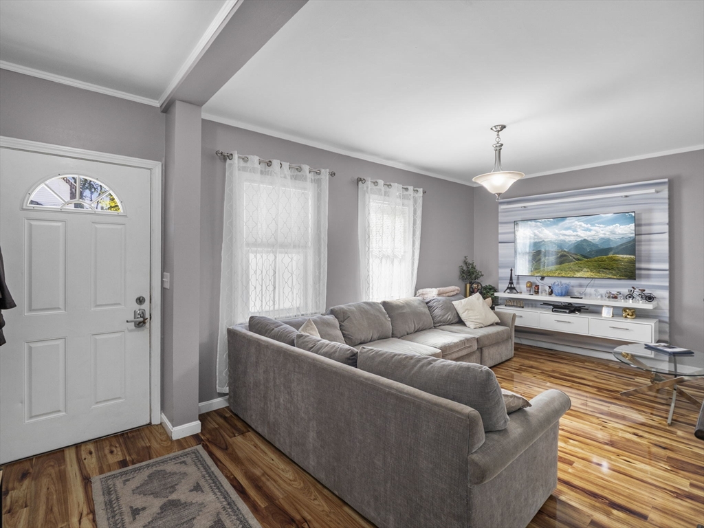 85 B Street Lowell, MA 01851 - Photo 6 of 42 a living room with furniture and a flat screen tv