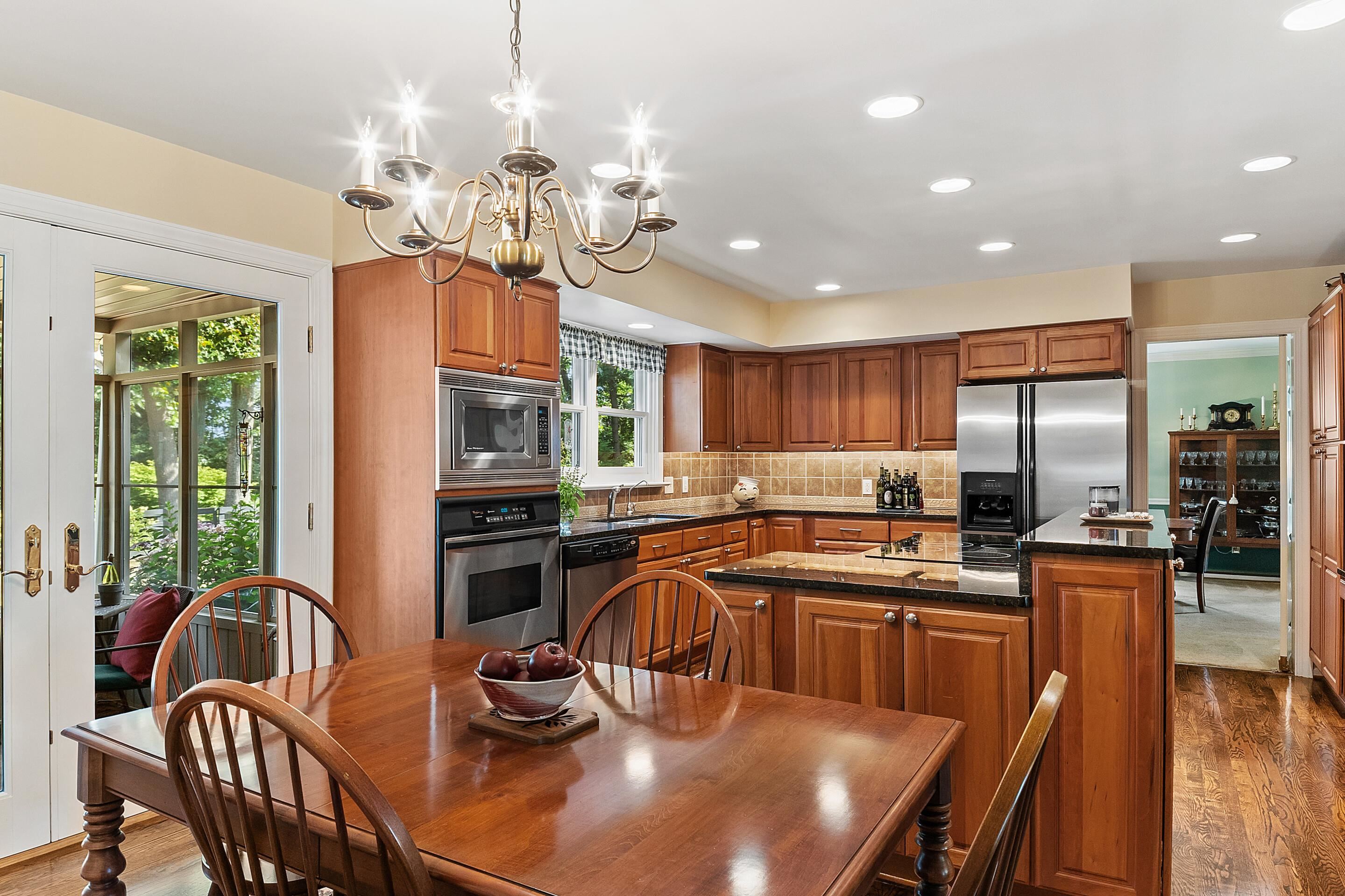 60 Roman Ridge Road Mount Sidney, VA 24467 - Photo 18 of 75 a kitchen with stainless steel appliances granite countertop a stove top oven a sink dishwasher a dining table and chairs with wooden floor