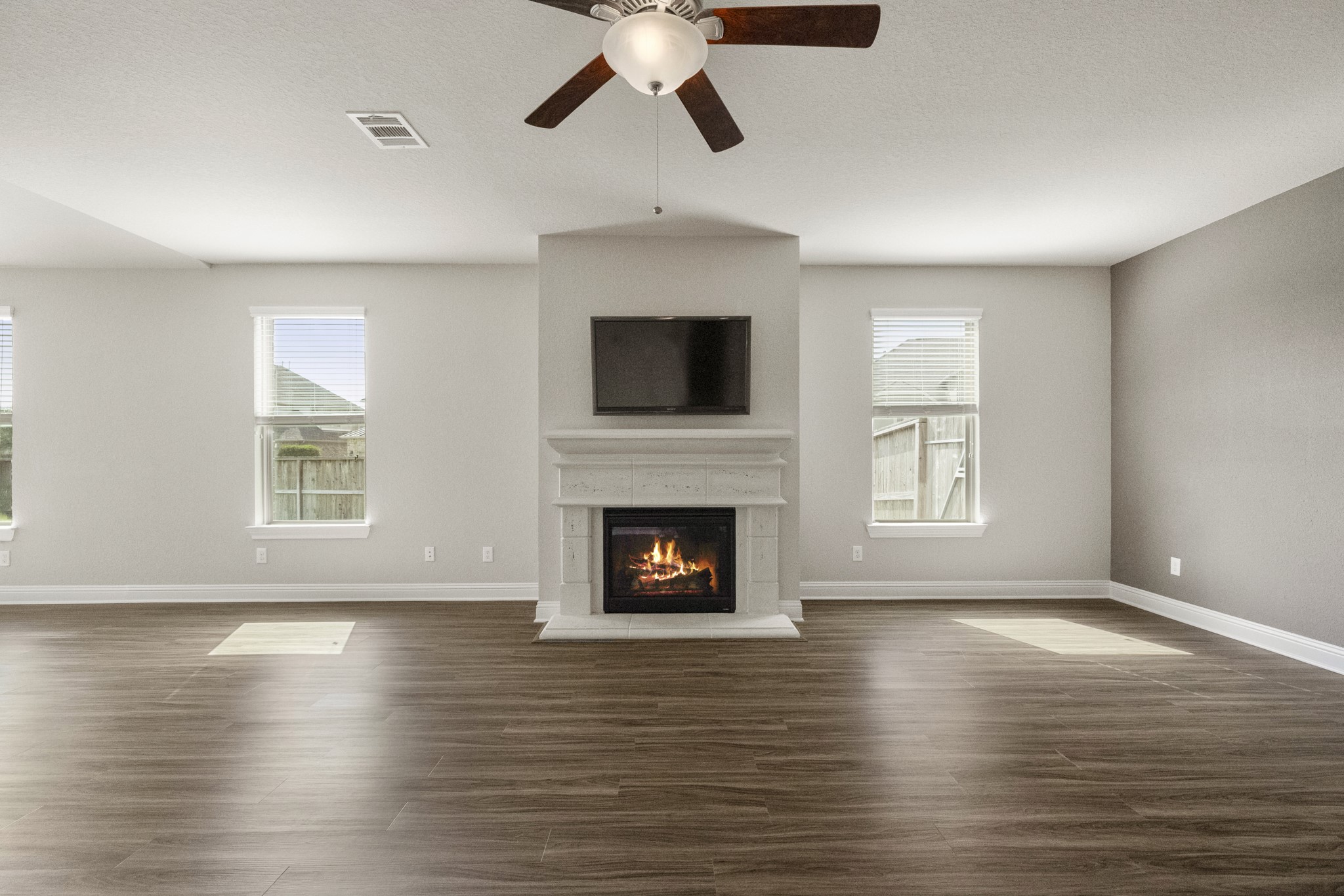 7502 Windsor Park Court Spring, TX 77379 - Photo 49 of 50 a living room with wooden floor and a fireplace