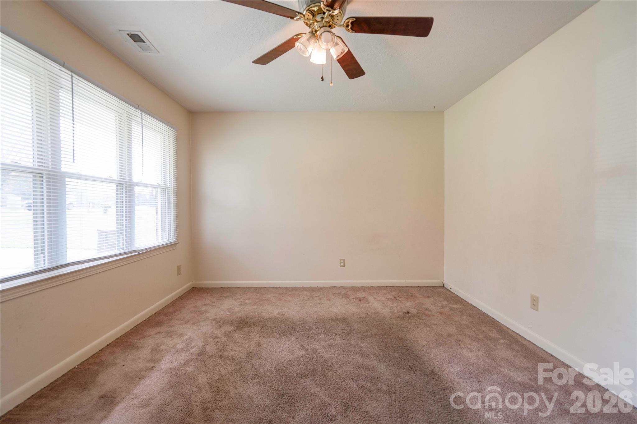 1904 Sulphur Springs Road Shelby, NC 28152 - Photo 3 of 27 an empty room with chandelier fan and windows