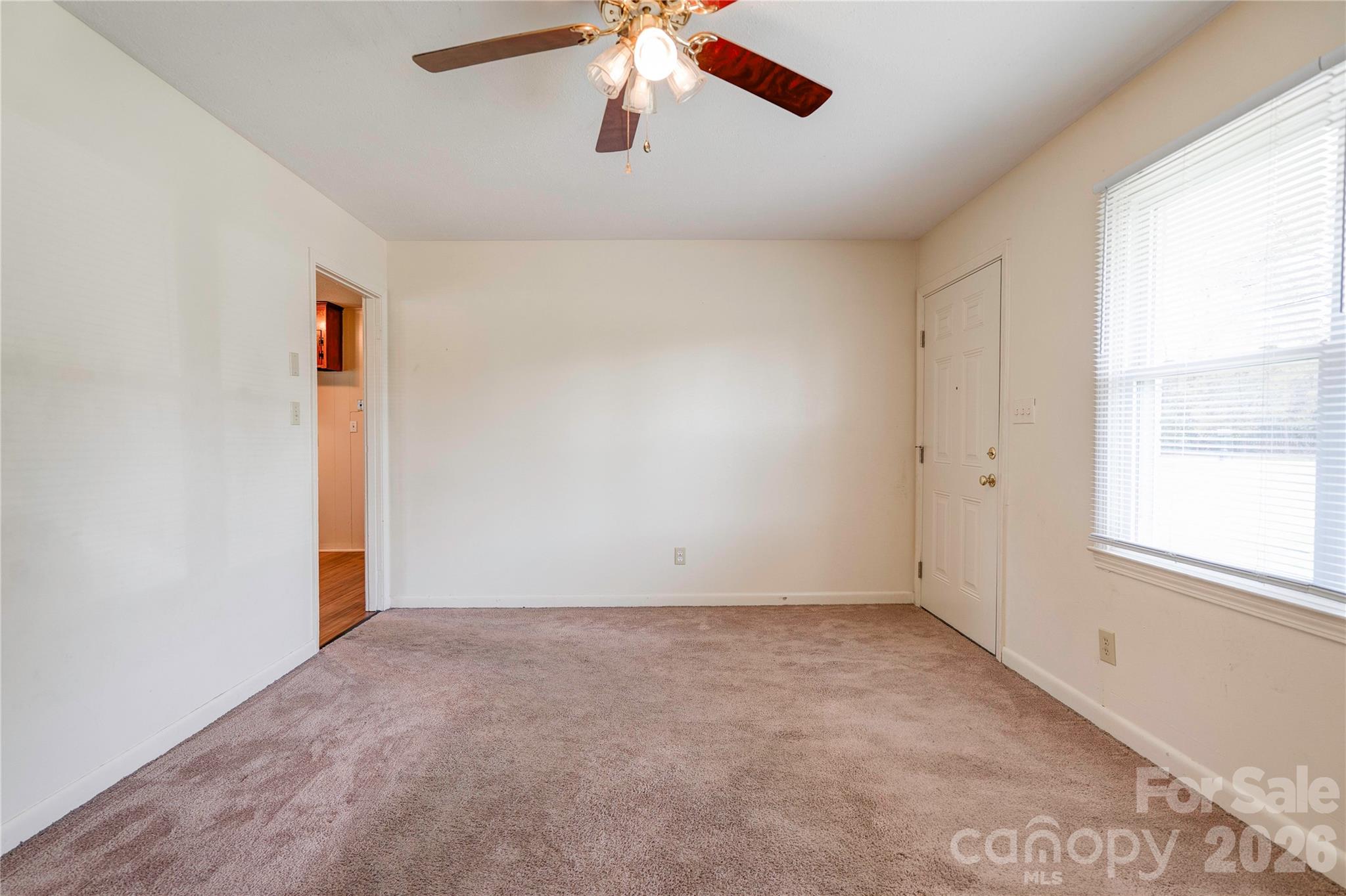 1904 Sulphur Springs Road Shelby, NC 28152 - Photo 4 of 27 an empty room with a window and a ceiling fan