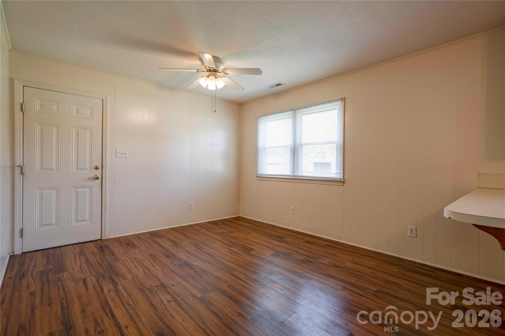 1904 Sulphur Springs Road Shelby, NC 28152 - Photo 6 of 27 a view of an empty room with wooden floor and a window
