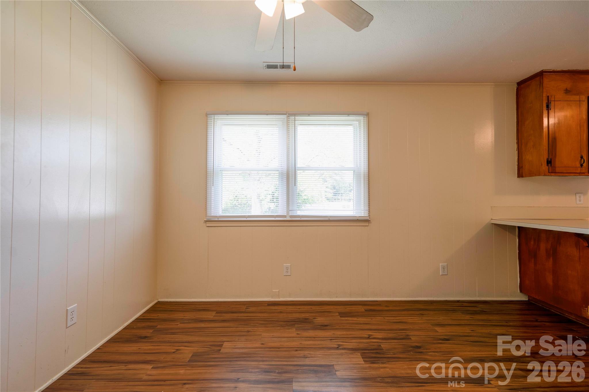 1904 Sulphur Springs Road Shelby, NC 28152 - Photo 7 of 27 an empty room with wooden floor chandelier fan and windows