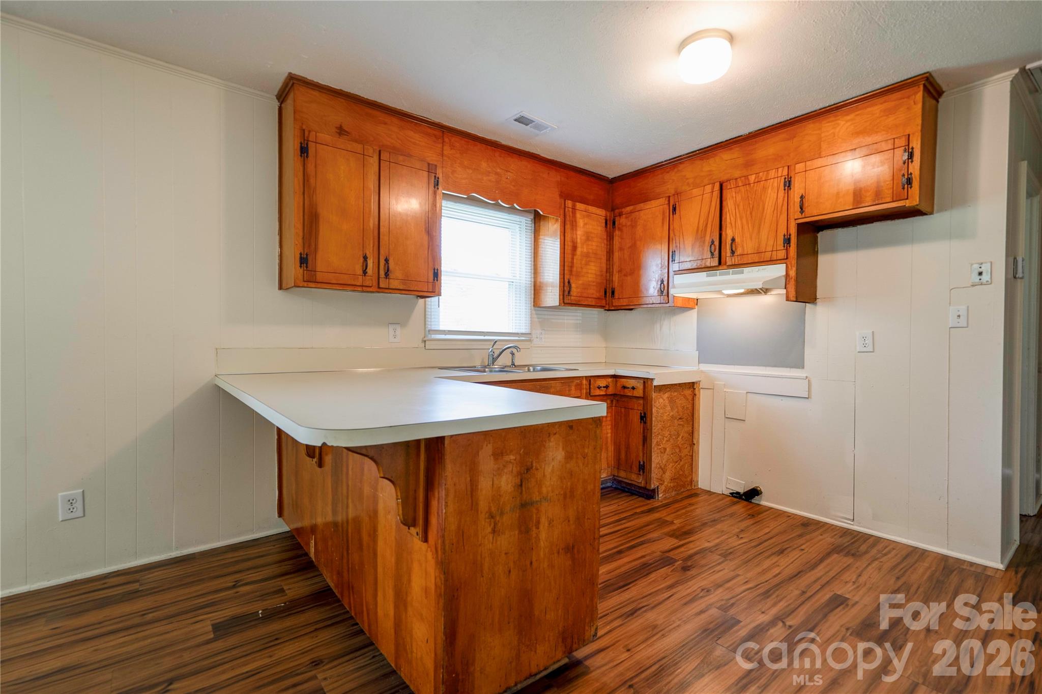 1904 Sulphur Springs Road Shelby, NC 28152 - Photo 8 of 27 a kitchen view with wooden floor a sink and a microwave