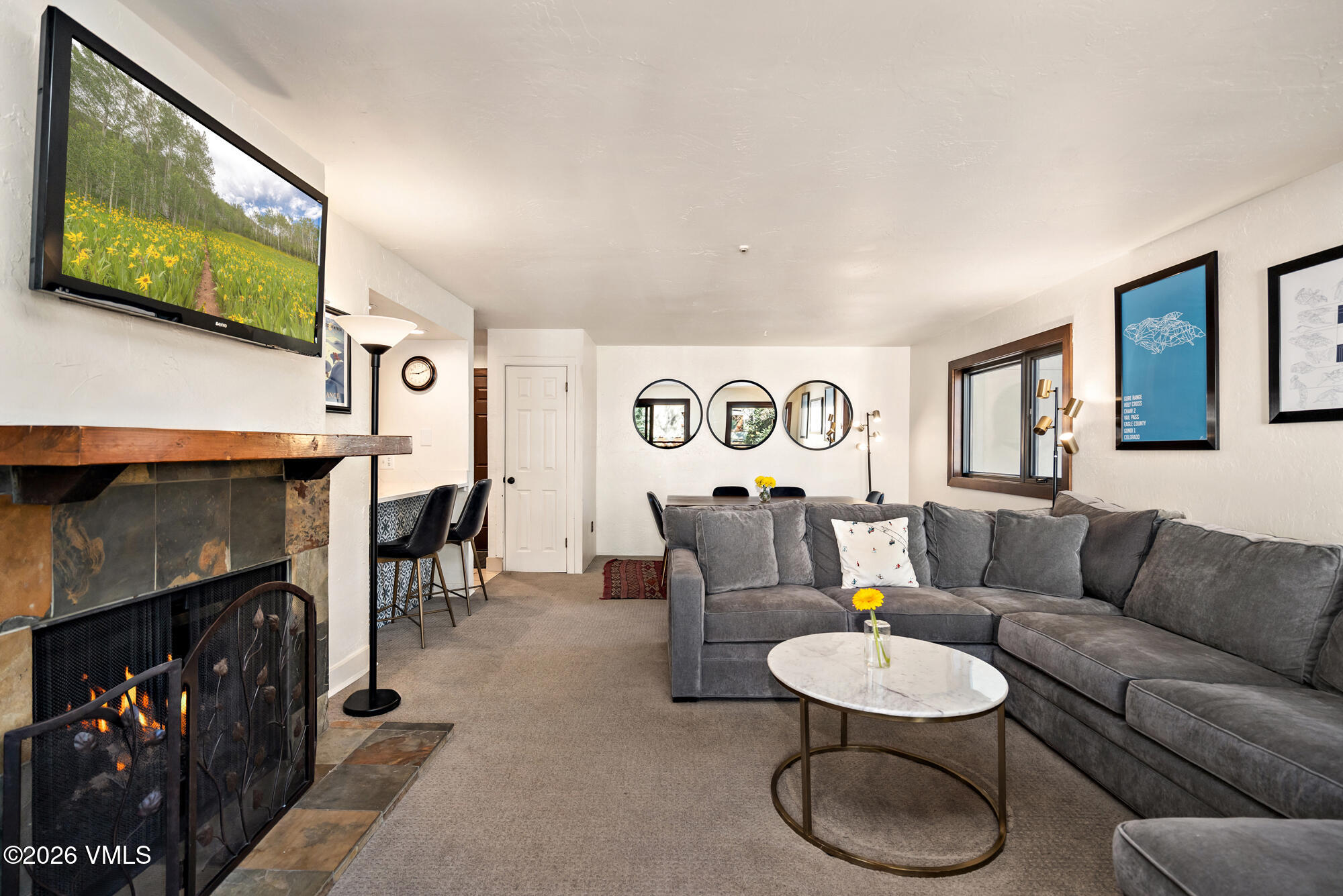 963 Lions Ridge Loop, Unit 502 Vail, CO 81657 - Photo 5 of 30 a living room with furniture a fireplace and a flat screen tv