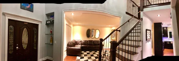 a view of entryway and hall with wooden floor