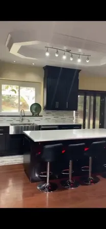 a bathroom with a sink a mirror and wooden floor