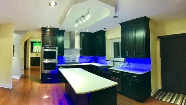 a kitchen with stainless steel appliances kitchen island granite countertop a refrigerator a stove and a sink