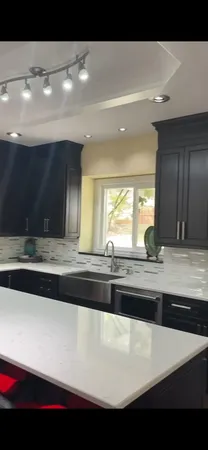 a view of kitchen sink and wooden floor