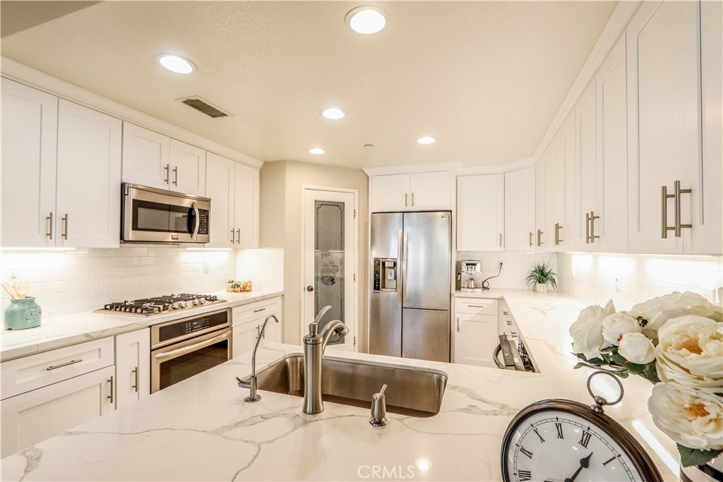 264 Lockford Irvine, CA 92602 - Photo 5 of 15 a kitchen with stainless steel appliances granite countertop a refrigerator and a stove top oven