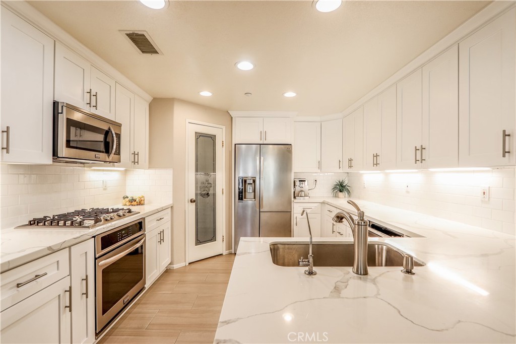 264 Lockford Irvine, CA 92602 - Photo 6 of 15 a kitchen with granite countertop a sink a counter top space stainless steel appliances and cabinets