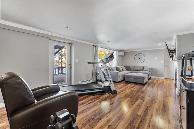 a living room with furniture a window and gym equipment