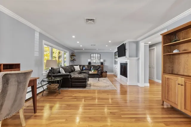 a living room with furniture wooden floor and a flat screen tv