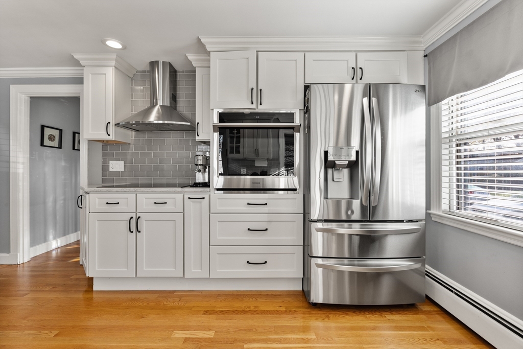 3 Suntaug Street Lynnfield, MA 01940 - Photo 18 of 42 a kitchen with stainless steel appliances granite countertop a refrigerator and a stove top oven