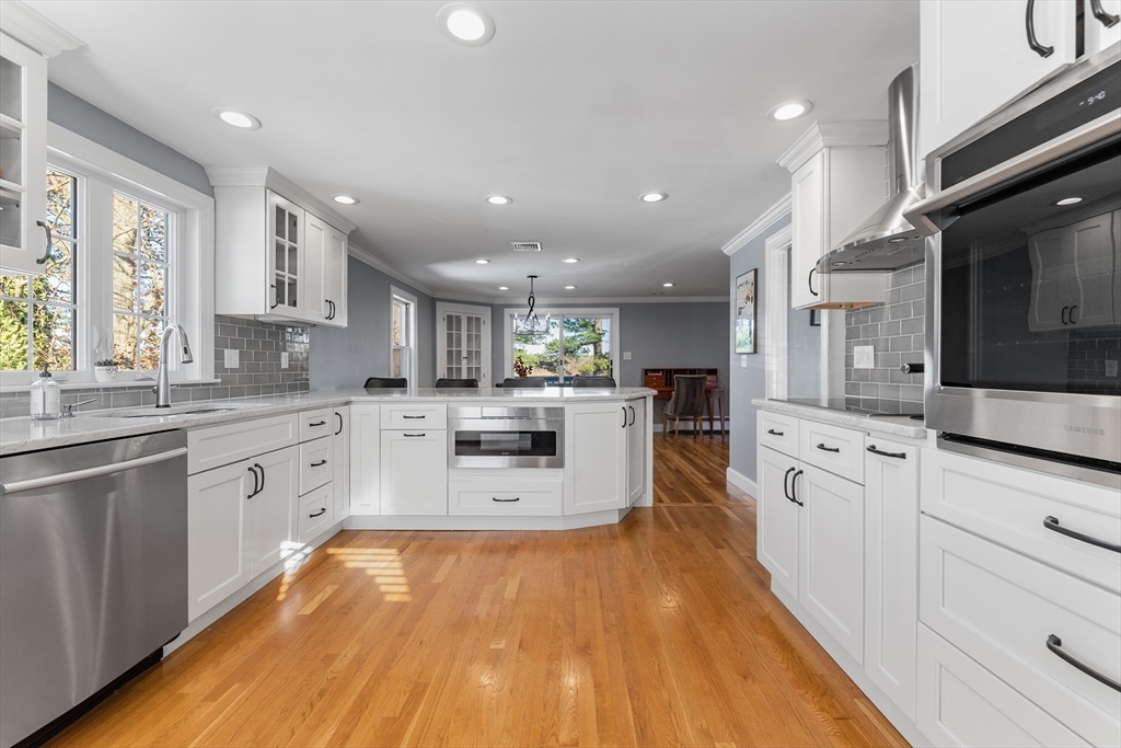 3 Suntaug Street Lynnfield, MA 01940 - Photo 20 of 42 a large kitchen with stainless steel appliances and white cabinets