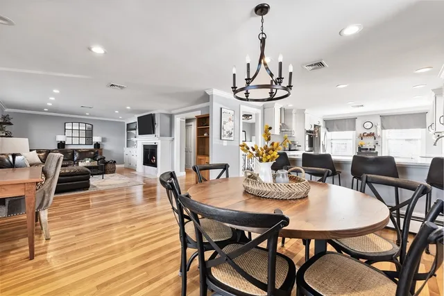 a view of a dining room with furniture wooden floor and chandelier