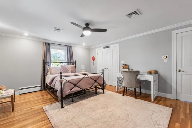 a bedroom with furniture and a wooden floor
