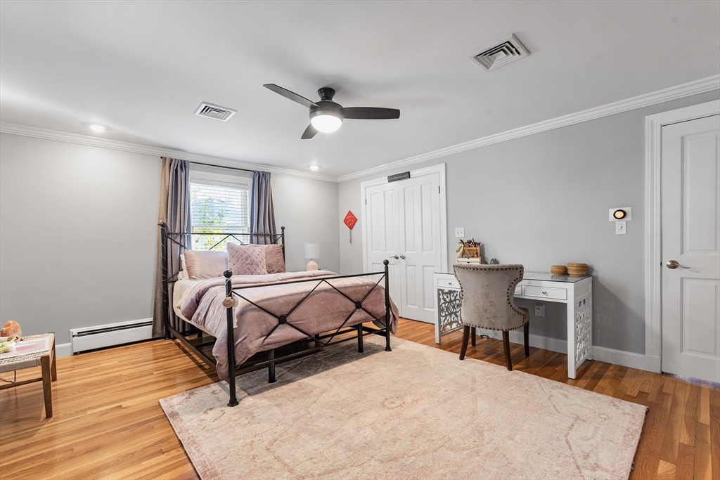 3 Suntaug Street Lynnfield, MA 01940 - Photo 28 of 42 a bedroom with furniture and a wooden floor