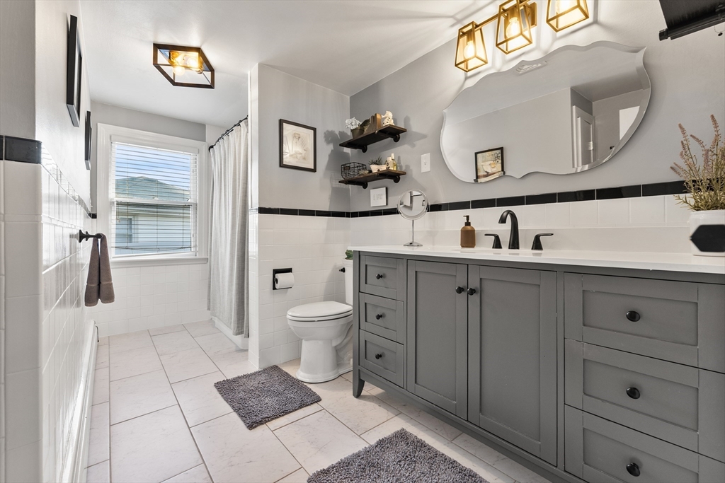 3 Suntaug Street Lynnfield, MA 01940 - Photo 32 of 42 a bathroom with a toilet sink and mirror