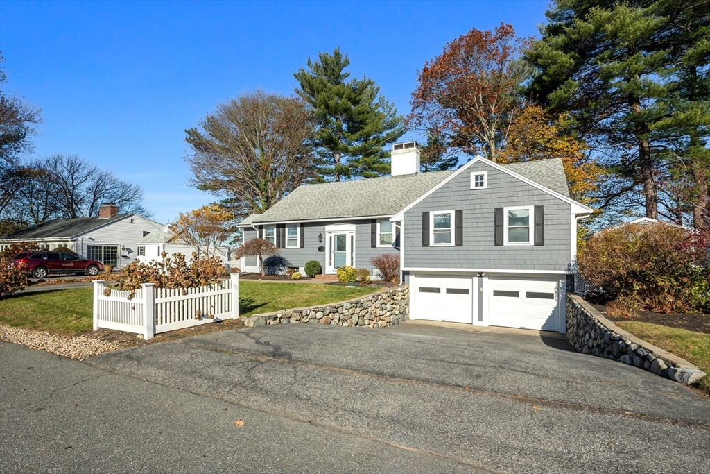 3 Suntaug Street Lynnfield, MA 01940 - Photo 34 of 42 a front view of a house with a yard with a large tree