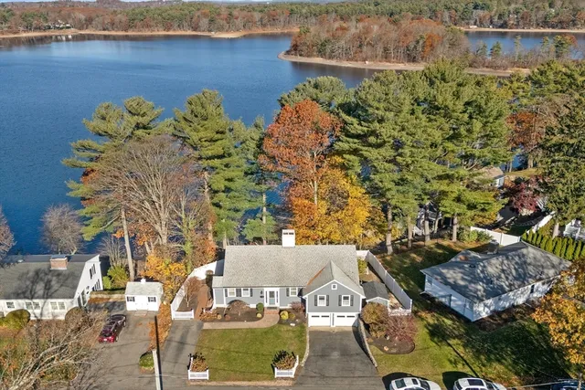 an aerial view of a house with a lake view