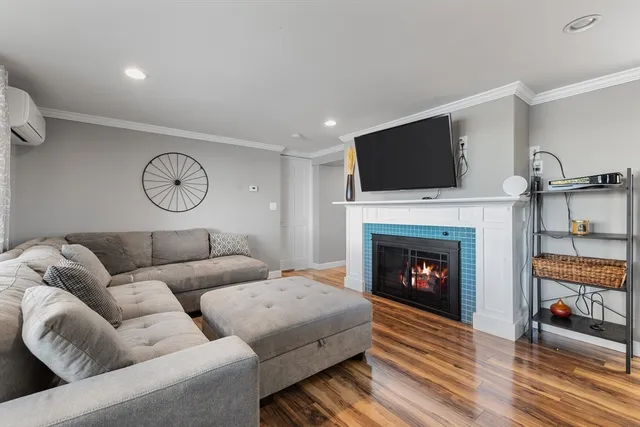 a living room with furniture a fireplace and a flat screen tv