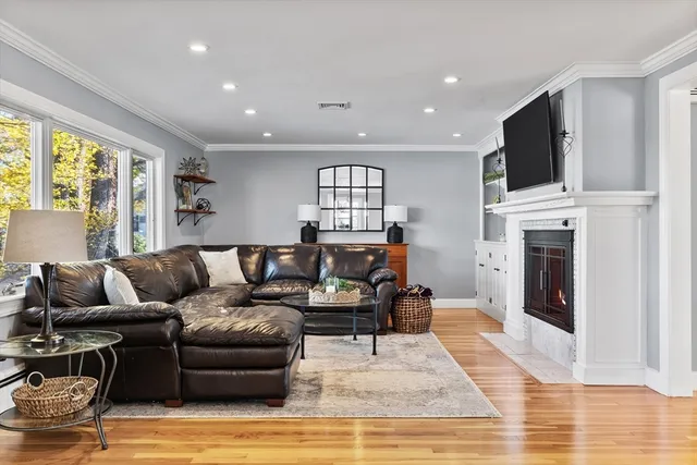 a living room with furniture fireplace and flat screen tv