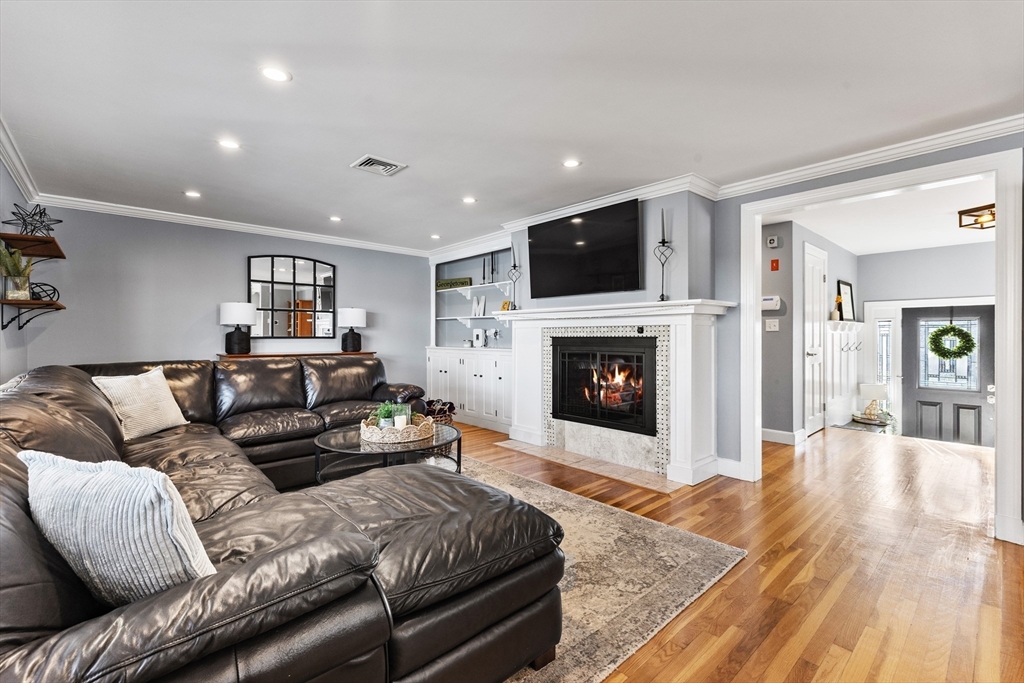 3 Suntaug Street Lynnfield, MA 01940 - Photo 9 of 42 a living room with furniture a flat screen tv and a fireplace