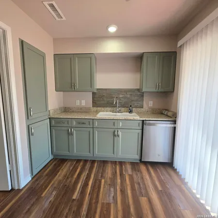 a kitchen with a sink window and cabinets