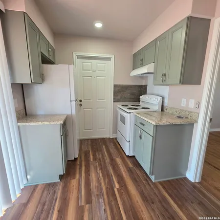 a kitchen with a sink stove and refrigerator