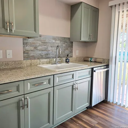 a kitchen with a sink cabinets and window